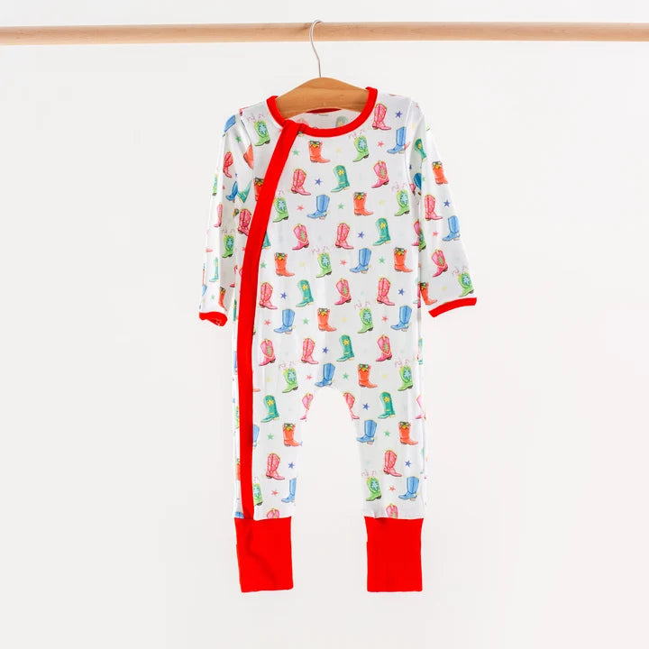 White long-sleeve baby pajamas with colorful cowboy boots and stars, a red-trimmed front zipper and red ankle cuffs.