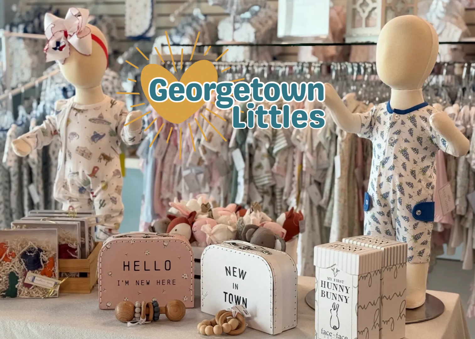 Display of children's clothing and accessories with 'Georgetown Littles' branding.