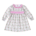Baby Loren long-sleeve Christmas tree print dress with a pink ruffled neckline, pink waistband, and ruffled cuffs.
